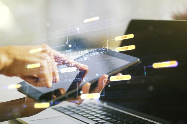 Multi exposure of abstract programming language hologram and hand working with a digital tablet on background artificial intelligence and machine learning concept