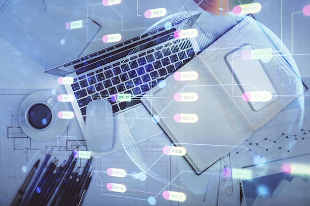 multi exposure of data drawing hologram over topview of study desk background with computer concept of technology