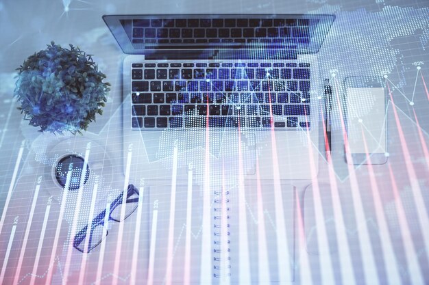 Multi exposure of forex chart drawing over table background with computer Concept of financial research and analysis Top view
