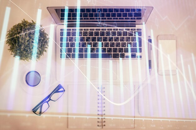 Multi exposure of forex chart drawing over table background with computer Concept of financial research and analysis Top view