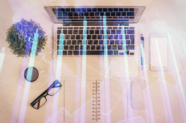 Multi exposure of forex chart drawing over table background with computer Concept of financial research and analysis Top view