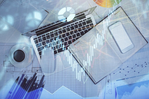 multi exposure of forex chart drawing over table background with computer concept of financial research and analysis top view