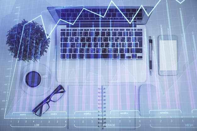 Multi exposure of forex chart drawing over table background with computer Concept of financial research and analysis Top view