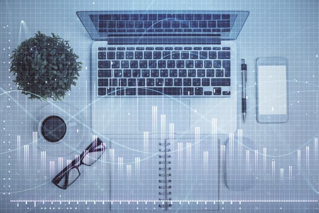 Multi exposure of forex chart drawing over table background with computer Concept of financial research and analysis Top view
