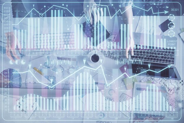 Multi exposure of man and woman working together and financial chart hologram Business concept Computer background