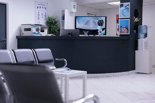 Nobody in hospital reception desk and waiting room at facility to attend medical consultation appointment. Waiting area lobby with chairs and counter at healthcare clinic, disease medicine.