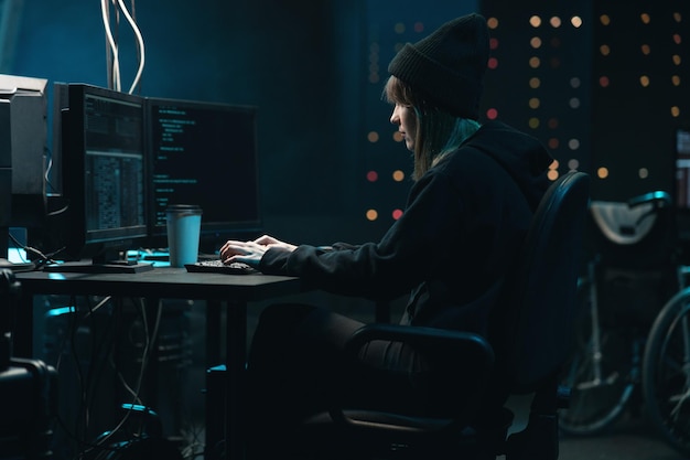 Nonconformist teenage hacker girl attacks corporate servers using her computer female hacker