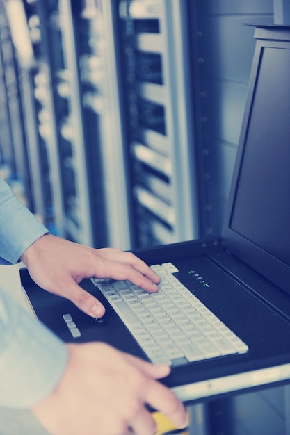 Nuori IT-insinööri palvelinkeskuksen palvelinhuoneessa