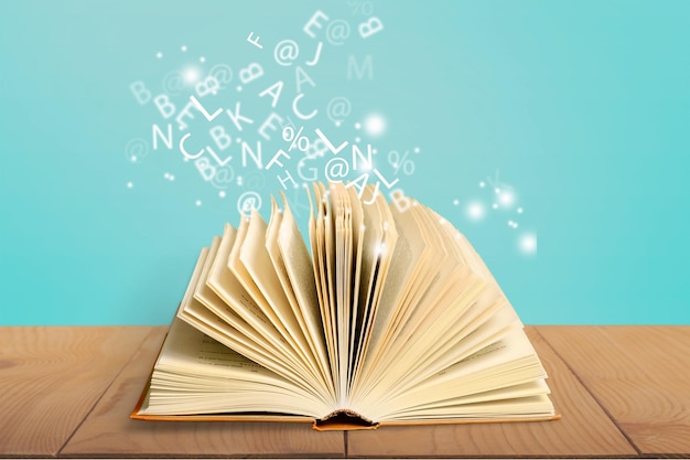 Open book isolated on white and letters flying away.Education concept
