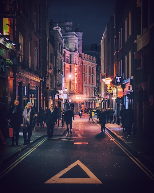 People walking on street at night
