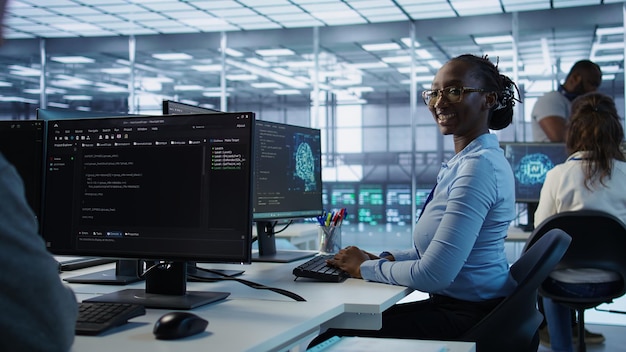 Portrait of smiling woman tasked with doing checkup on server room