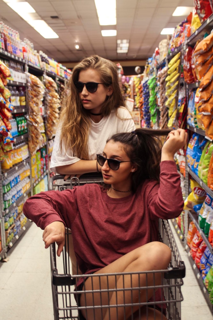 Kuva portrait of young women messing around in supermarket