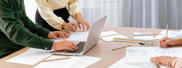 Professional architect edited blueprint by using laptop closeup delineation