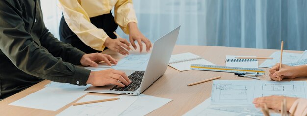 Professional architect edited blueprint by using laptop closeup delineation