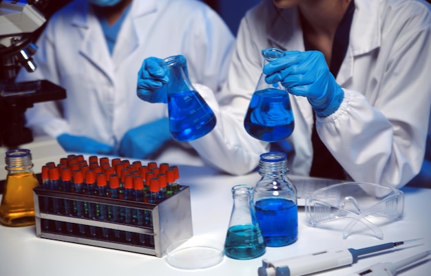 professional chemist woman laboratory using scientific microscope for science research chemistry scientist with microbiology medicals equipment technology to working with medicine biology experiment