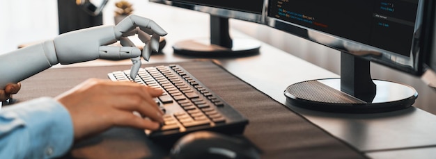 Program coding automation by generative artificial intelligence or AI concept Collaboration between robotic hand and human software developer solving debugging or writing scriptTrailblazing