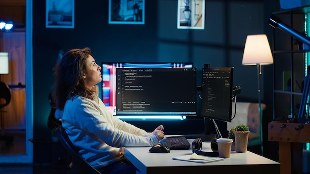 Programmer checking code on computer monitor and AR visualization