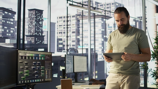 Programmer developing machine learning APIs checking performance on tablet