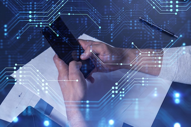 Programmer holding in the hands a smart phone and testing an innovative application to provide a completely new service Close up shot Hologram tech graphs Concept of Dev team