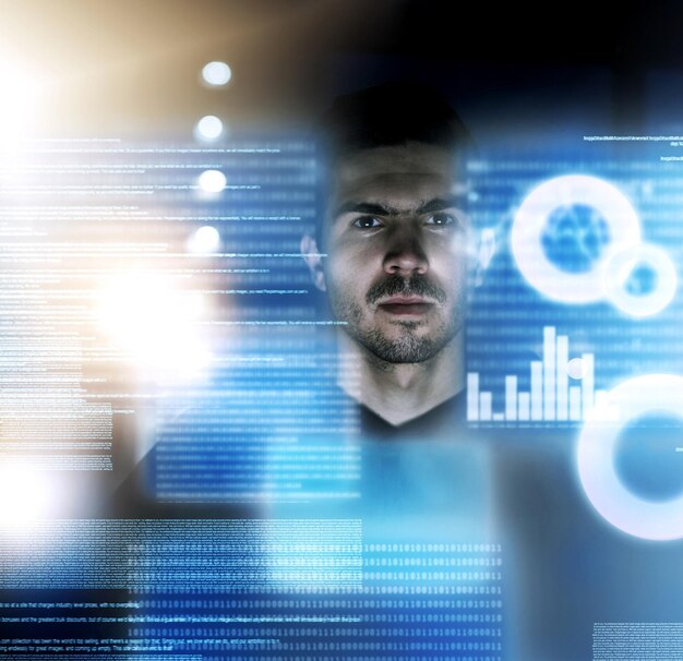Programmer man and serious for hologram online and portrait of coding in night for deadline of company Graph future and software for overlay digital and cyber security of business in office