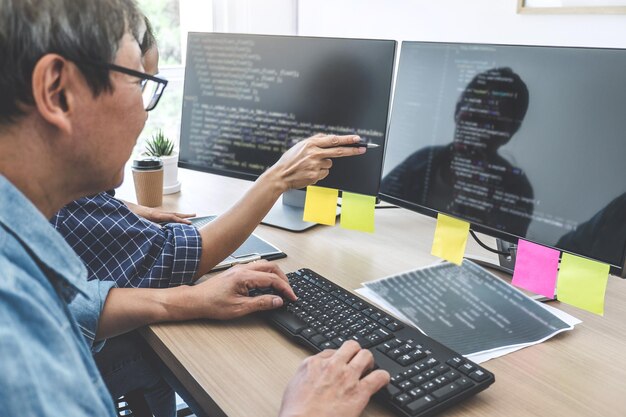 Programmers using computers at office desk