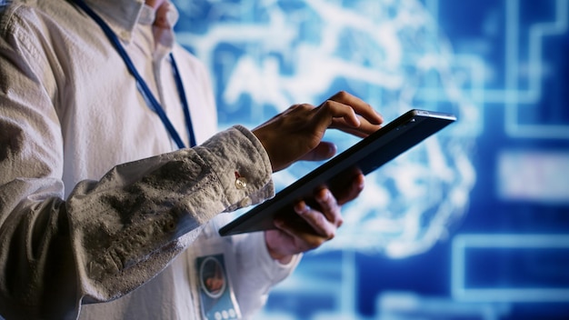 Qualified admin works with artificial intelligence computerized model simulating human brain. Proficient expert looks at AI visualization showing machine learning algorithms using pattern recognition