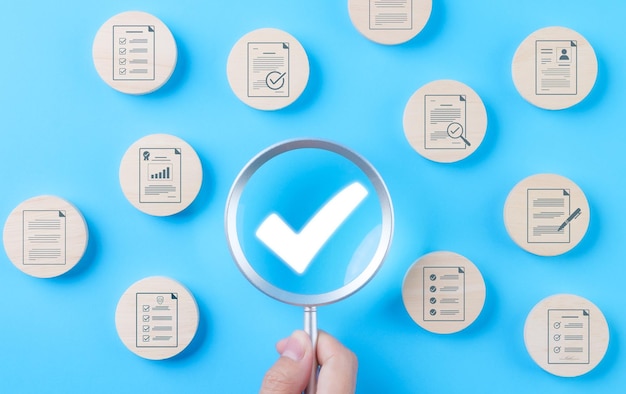 Quality assurance document control concept Magnifying glass focus on checkmark for document approved paperless and quality assurance approve Quality standard certificate Correct sign mark