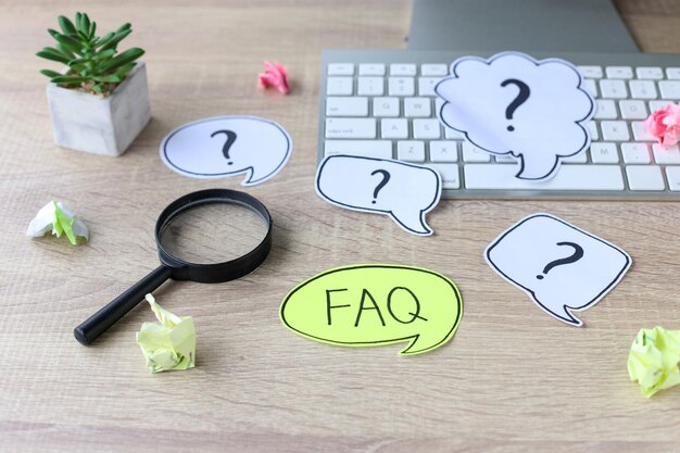 question mark and word faq on office desk. working with clients. troubles in work.