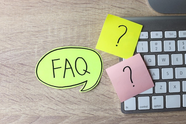 question mark on sticky notes and faq writing on sticky note at office desk faq concept working wi