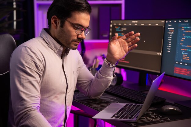 Serious smart IT developer meeting via application team record laptop Surmise