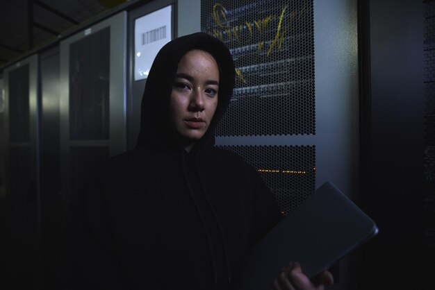 Server hacker and database with portrait of woman for coding software and cyber security Ransomware phishing and developer with girl programmer at night for programming network and digital crime