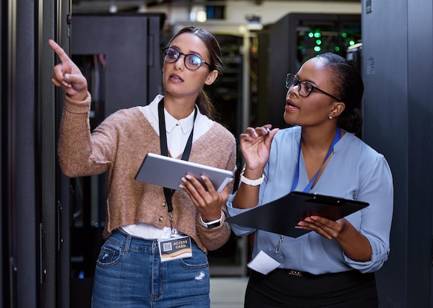 Server technician and people programming maintenance on tablet with teamwork in IT and engineering Datacenter repair and programmer with engineer problem solving to fix technology in collaboration