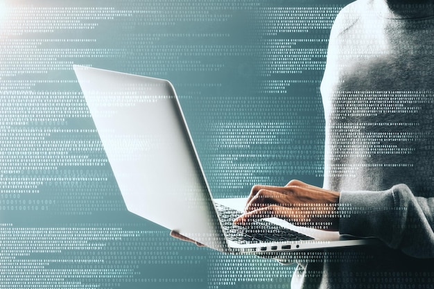 Side view and close up of hacker using laptop with creative binary code interface Software and criminal concept Double exposure