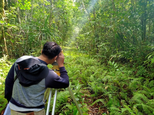 Side view of young man in forest