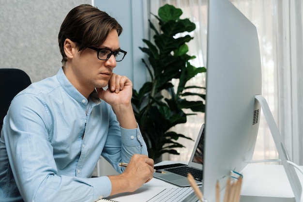 Smart marketing communication manager working on pc and laptop Pecuniary