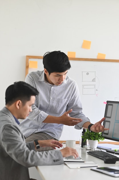 Software developer meeting with designer