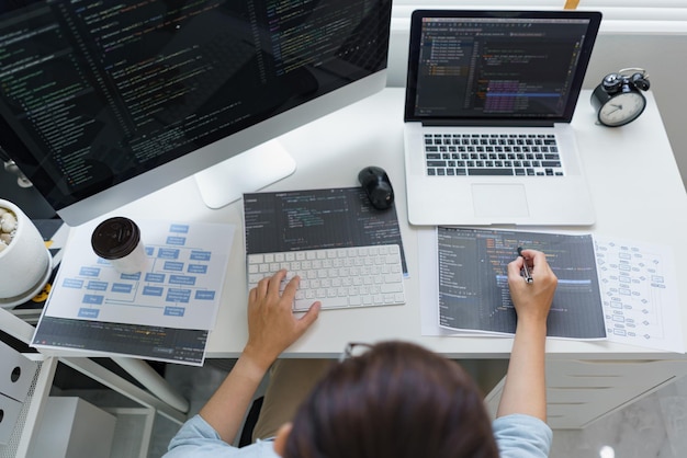Software development concept male programmer pointing on data code to checking website programming