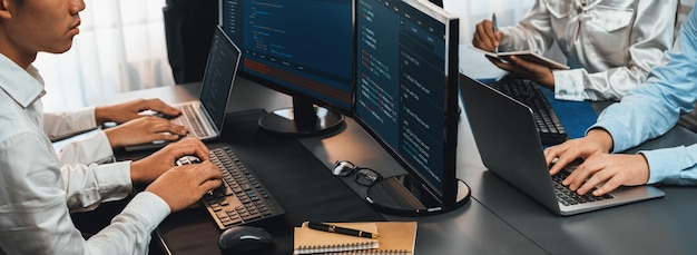 Software development team working together in office coding script display on computer monitor Programmer and software engineer working in tech developer company Trailblazing