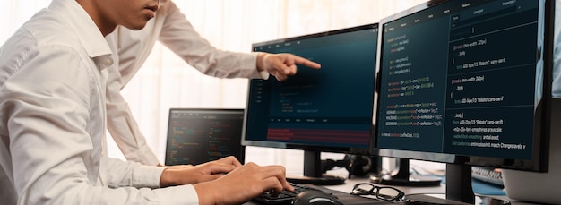 Software development team working together in office coding script display on computer monitor Programmer and software engineer working in tech developer company Trailblazing