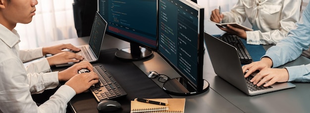 Software development team working together in office coding script display on computer monitor Programmer and software engineer working in tech developer company Trailblazing