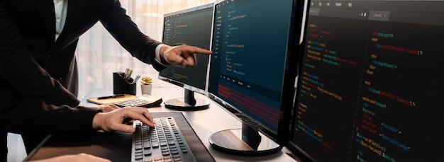Software development team working together in office coding script display on computer monitor Programmer and software engineer working in tech developer company Trailblazing