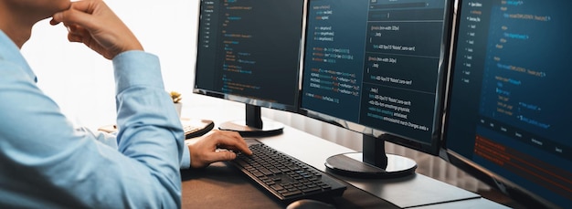 Software engineer working on application development on his computer display code and script on monitor at tech company office workplace Application developer solving and writing code Trailblazing