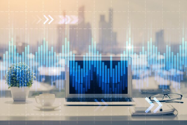 stock market graph on background with desk and personal computer multi exposure concept of financial analysis