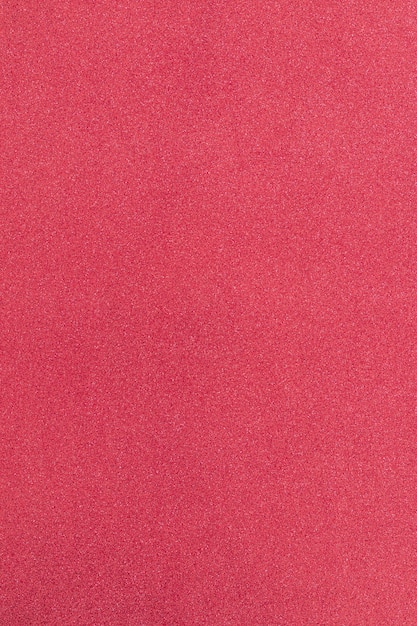 strawberry colored background with microstructure and sparkles (macro focus)