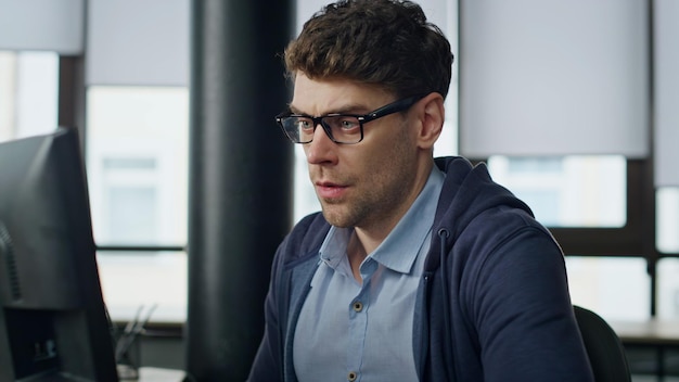 Stressed businessman analyzing computer report closeup nervous it manager look