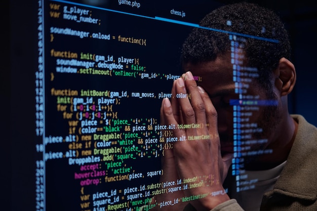 Stressed Developer Reviewing Complex Code on Screen