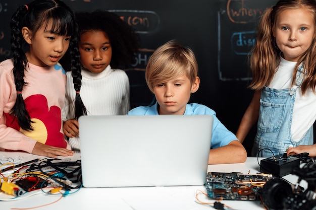 Student learn about coding robotics car in STEM class with attention Erudition