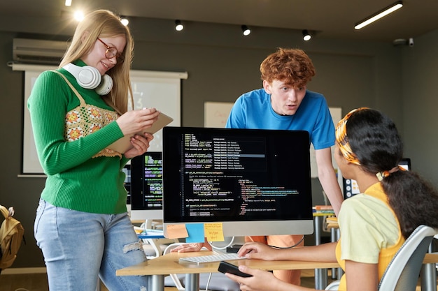 Students working on programming code together
