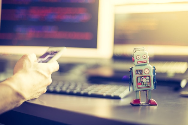 Symbol for a chatbot or social bot and algorithms program code in the background
