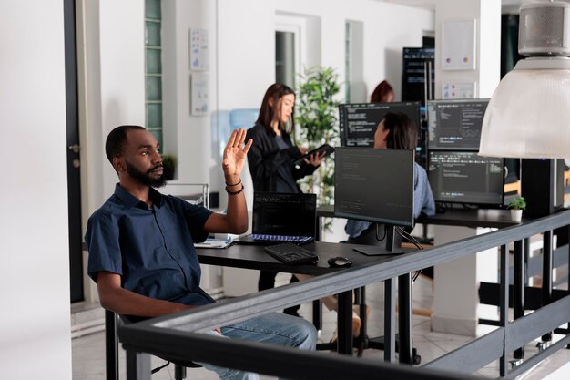System engineer looking at ar hologram to work on data script, using holographic database interface with augmented reality. Cloud computing program with terminal window software company